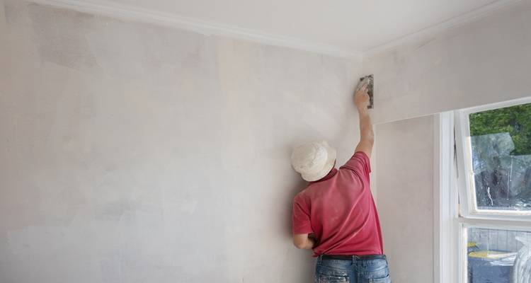 man red t shirt plastering room