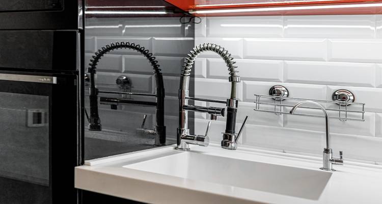glossy white tiles tap with hose
