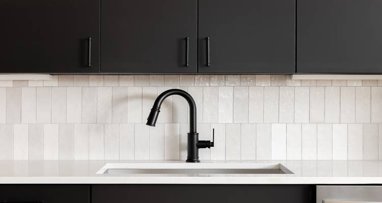 white textured subway tiles black tap