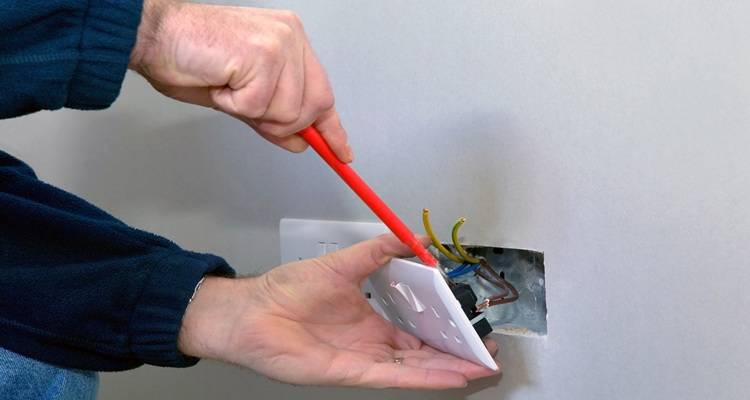 Hand installing plug socket