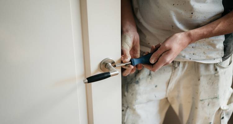 man fitting door handle