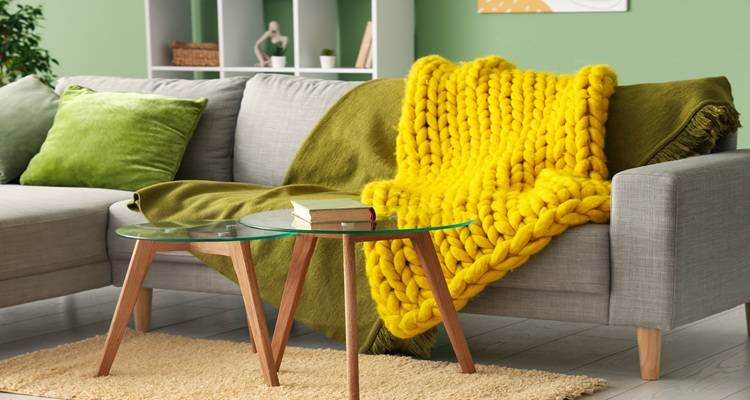green sofa yellow cushion blanket