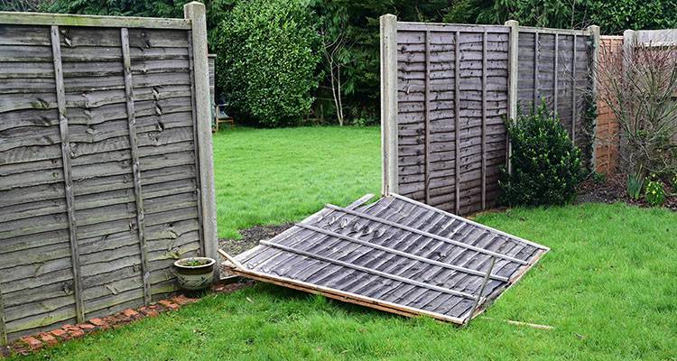 broken fence panels after storm damage