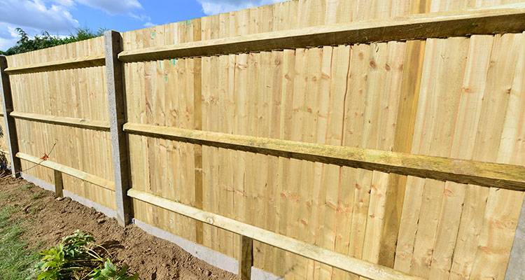 person repairing old worn fence