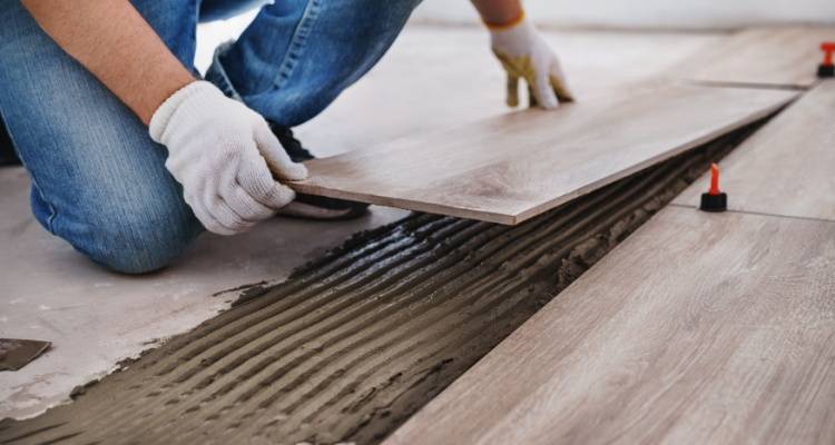 person laying tiles