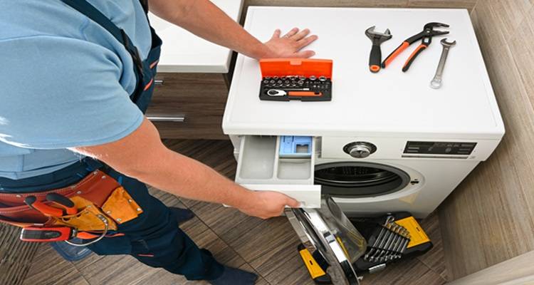 washing machine being fixed