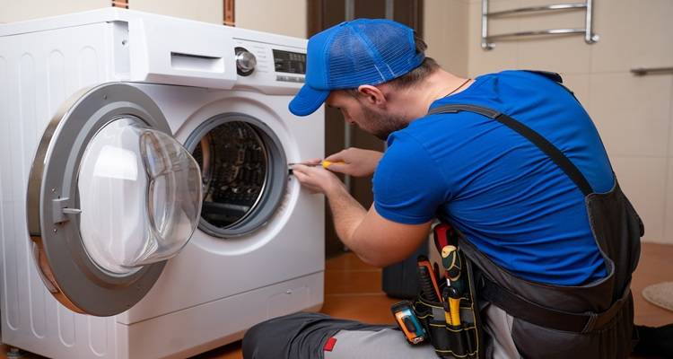 man repairing washing machine