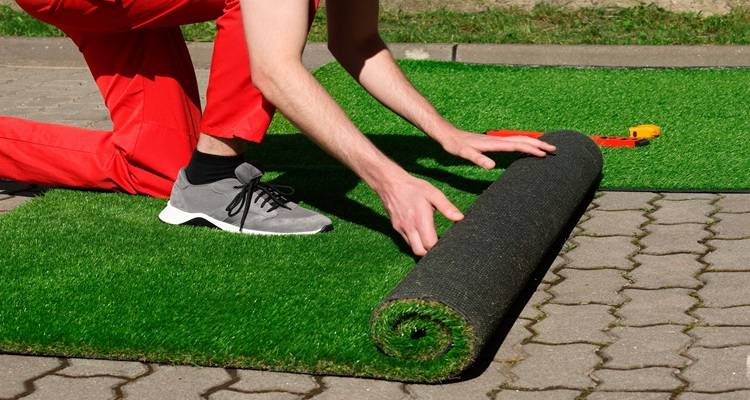 man red pants laying turf fake