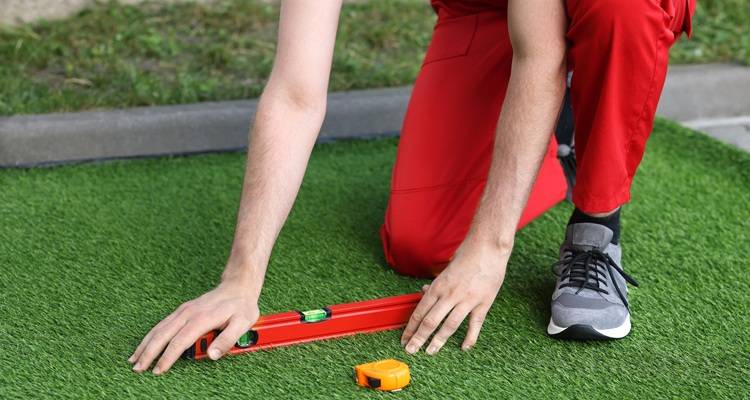 man red pants and tools fake grass
