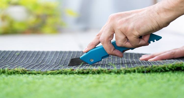 blue knife cutting fake grass