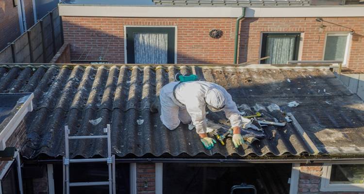 man removing asbestos roof