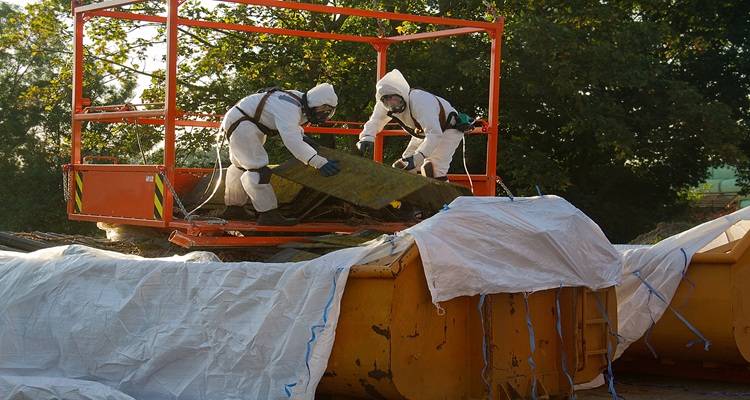 two people ppe asbestos skip