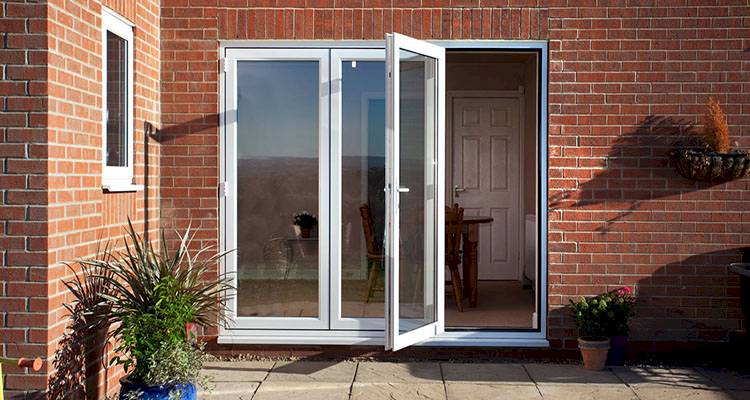 small white uPVC bifold door installation with three glass panels