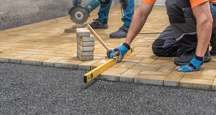 man laying pavers