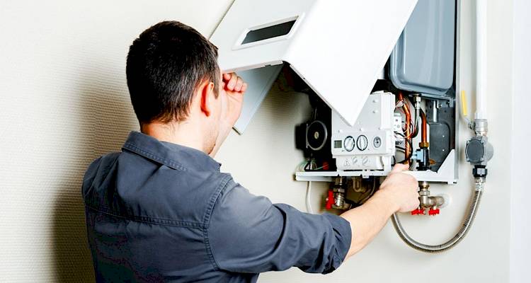 front of boiler being examined by a heating engineer