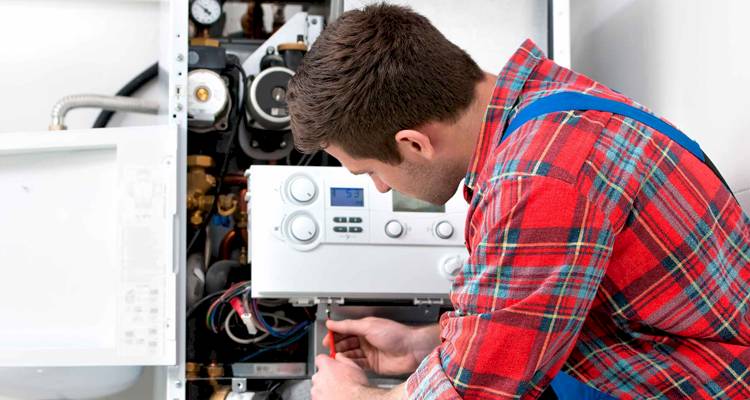heating engineer in process of moving a boiler