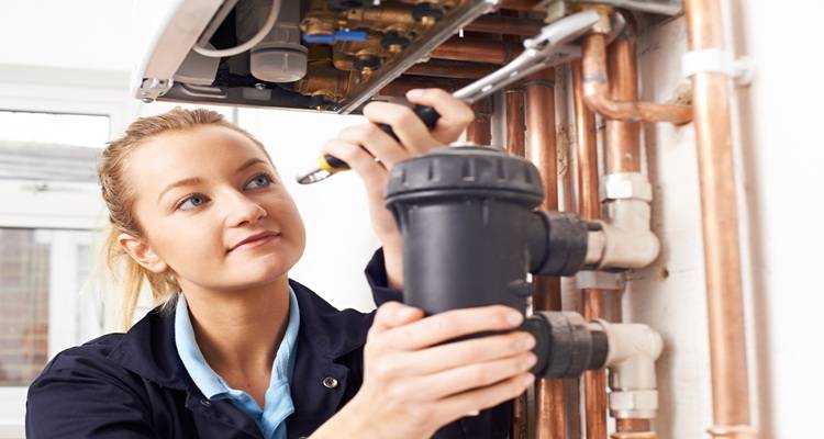 woman fixing boiler black part
