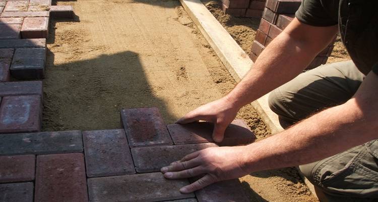 red bricks bring laid by hands