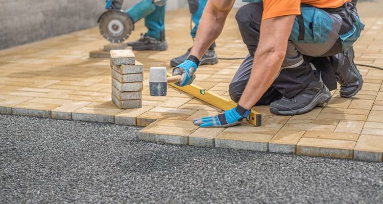 two men laying bricks