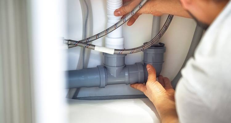 under sink pipes being fixed