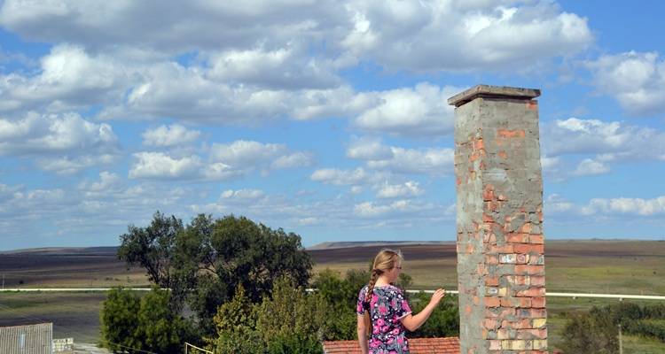 woman on roof tall house chimney