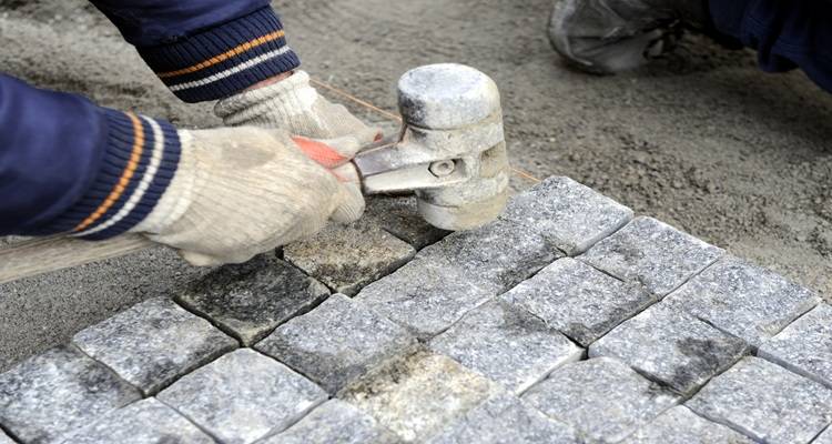 hand laying cobblestones