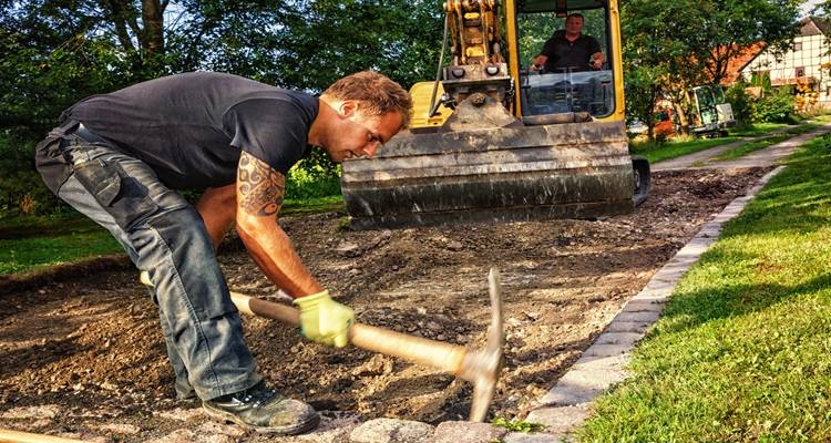 man diggin drive up pick axe