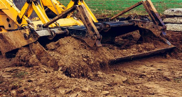 yellow excavtor digging