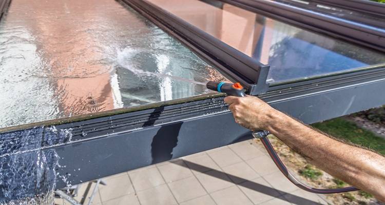 man washing roof