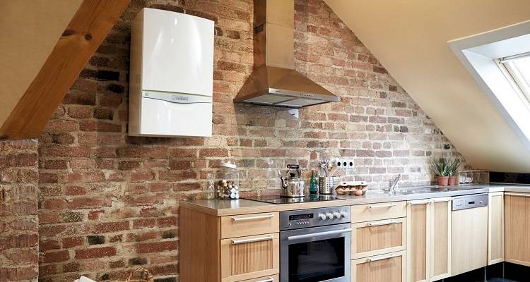 boiler installation cost guide &mdash; new boiler fitted onto the wall after a house renovation