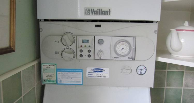 boiler installation cost guide &mdash; old boiler being replaced for modern model