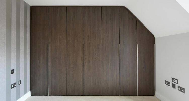 fitted wardrobe that has been custom designed to fit a space
