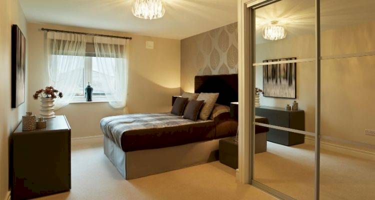 fitted sliding mirror wardrobe in a bedroom