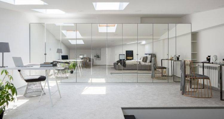 large sliding mirrored fitted wardrobes in a bedroom