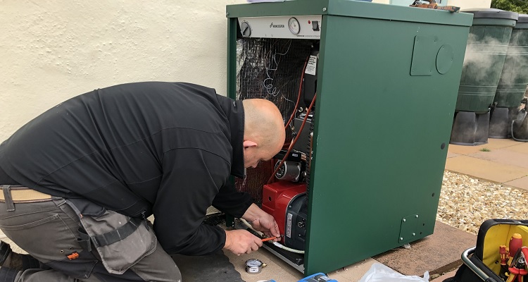 oil boiler being installed by a heating engineer