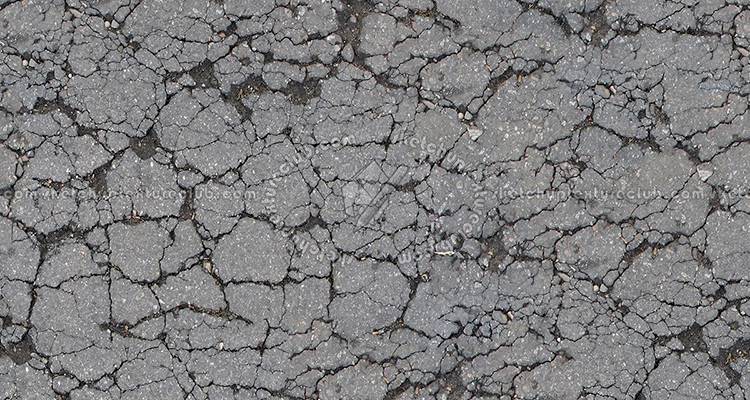 closeup of cracked tarmac driveway
