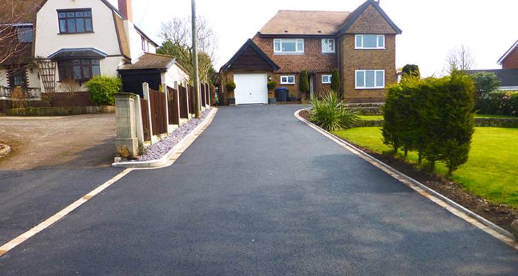 a new tarmac driveway installed on a long UK drive