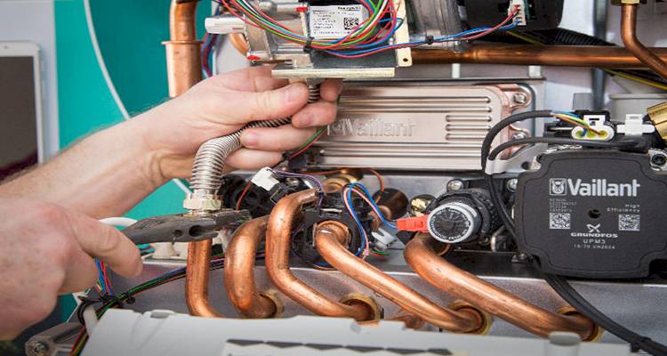 closeup of a heating engineer doing a gas boiler service