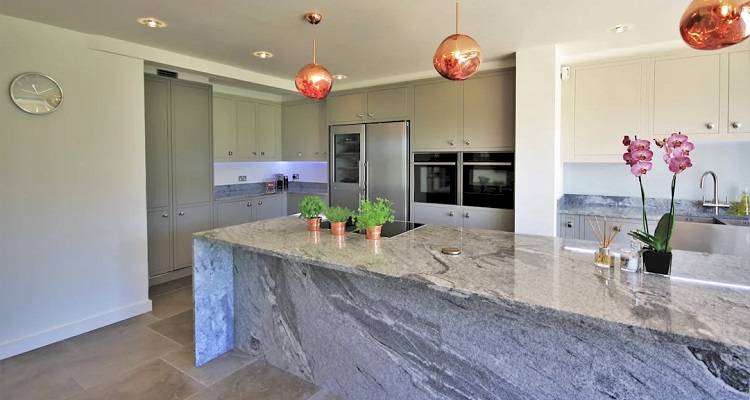 a remodelled kitchen with granite countertops