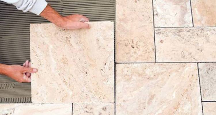 tiler laying floor tiles
