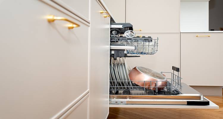 an open integrated dishwasher that is full of dishes