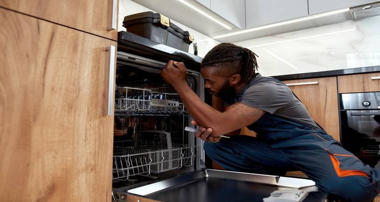 man fixing dishwasher