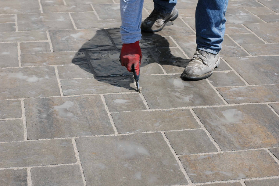 person installing block paving