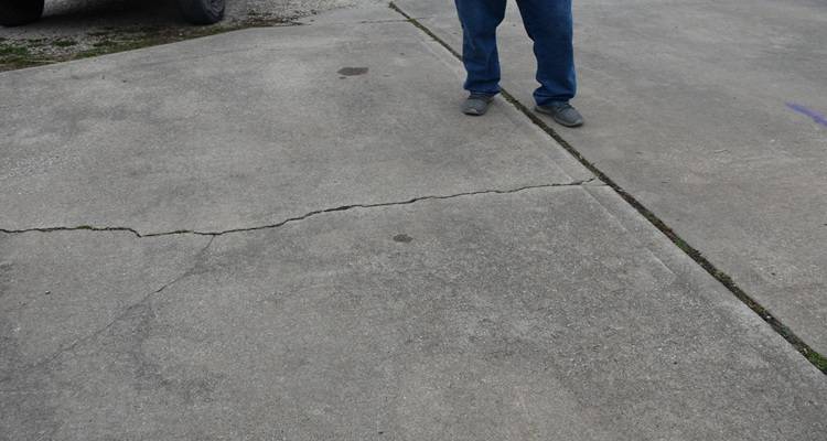 cracked driveway pair of feet