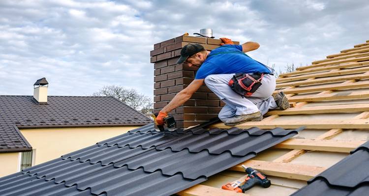 roofer on roof black tiles