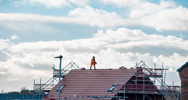 man on roof in distance