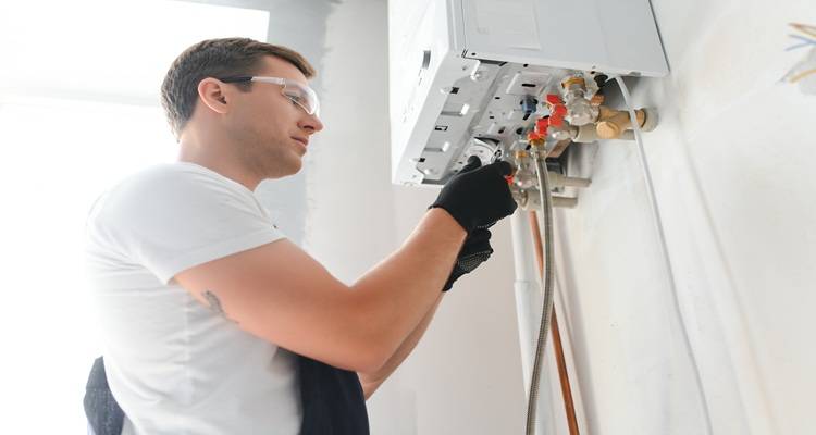 man fitting boiler