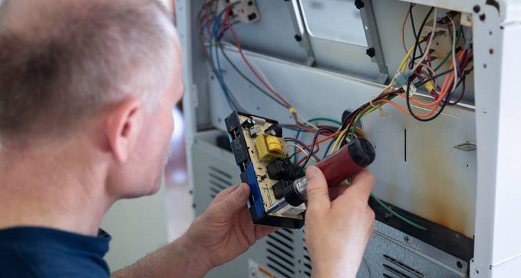 man with hands fixing oven