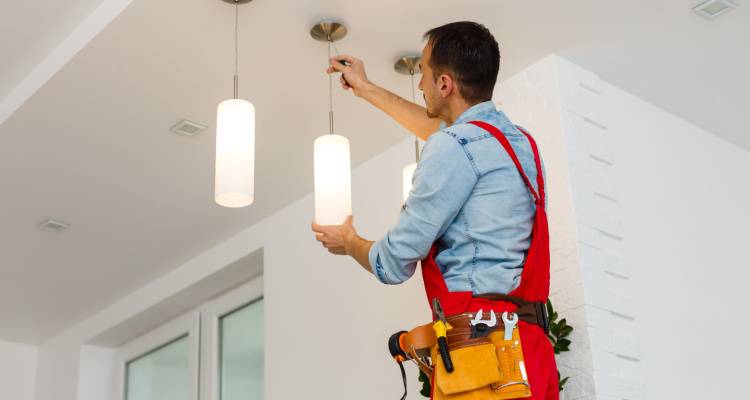 electrician installing light