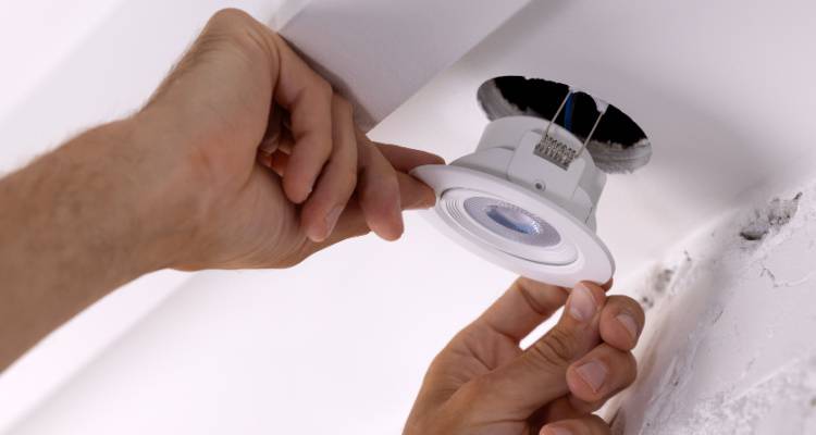 electrician installing spot light